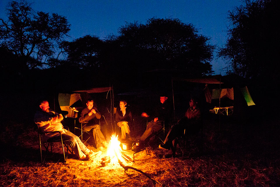 Sitting around the campfire on an Okavango Expeditions safari